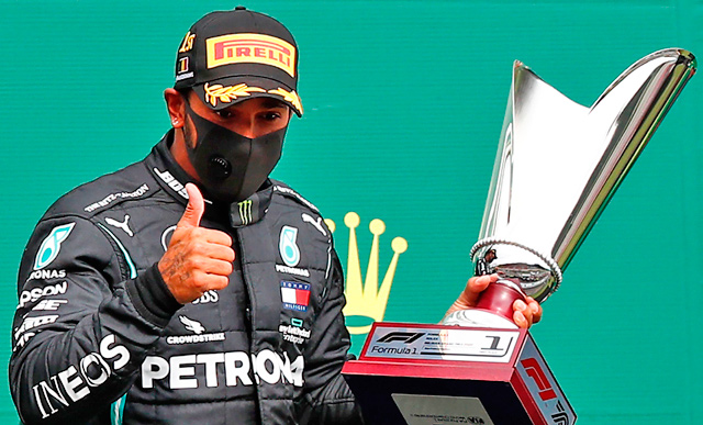 Mercedes' British driver Lewis Hamilton gestures on the podium after winning the Belgian Formula One Grand Prix at the Spa-Francorchamps circuit in Spa on Sunday  (AFP photo by Francois Lenoir)