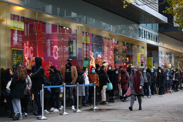 Shoppers queue outside Debenhams on Oxford Street in London on Sunday (AFP photo)