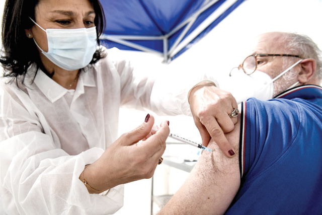 A medic, who is over 50-years-old, receives the Pfizer-BioNTech COVID-19 vaccine, at a vaccination centre, in Sarcelles near Paris, on Sunday (AFP photo)