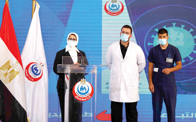 Egyptian Health Minister Hala Zayed (left) gives a press conference, accompanied by doctor Abdelmouim Selem (centre) and medical staff member Ahmed Hemdan, in a tent set up outside the Abou Khalifa Hospital in Ismailia, about 120km east the capital Cairo, on Sunday (AFP photo)