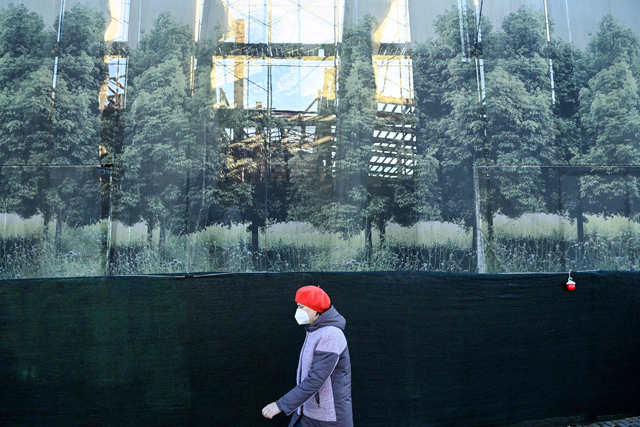 A woman wearing a face mask to protect against the coronavirus disease walks in Moscow  on Monday (AFP photo)