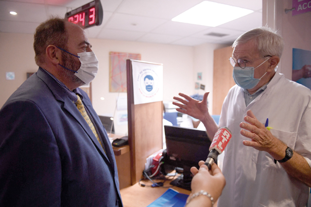 French Health Minister Francois Braun (left) chats with a doctor in charge of the vaccination at a Monkeypox vaccination site in Paris on Wednesday (AFP photo)