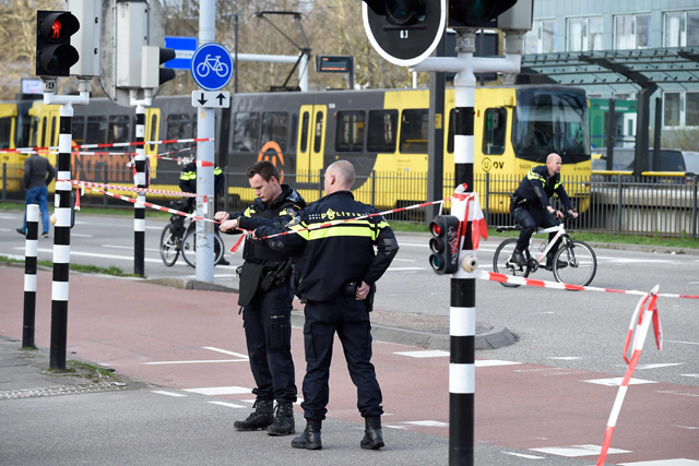 Policemen are at work on Monday in Utrecht, near a tram where a gunman opened fire killing at least three persons and wounding several in what officials said was a possible terrorist incident (AFP photo)