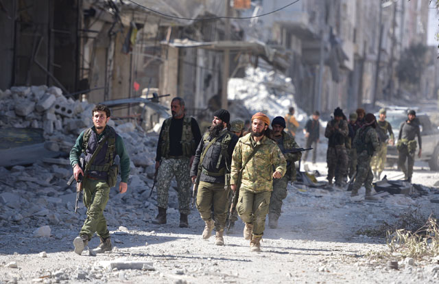 Members of Free Syrian Army patrol in the Syrian town of Al Bab after the town centre has been entirely freed from Daesh terrorists as part of the operation ‘Euphrates Shield’, Aleppo, Syria, on Thursday (Anadolu Agency photo)