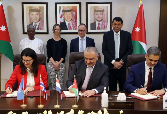 Minister of Planning and International Cooperation Nasser Shraideh, ILO Assistant Director-General and Regional Director for Arab States Ruba Jaradat, and SSC Director General Hazim Rahahleh sign an agreement on Tuesday (Petra photo)