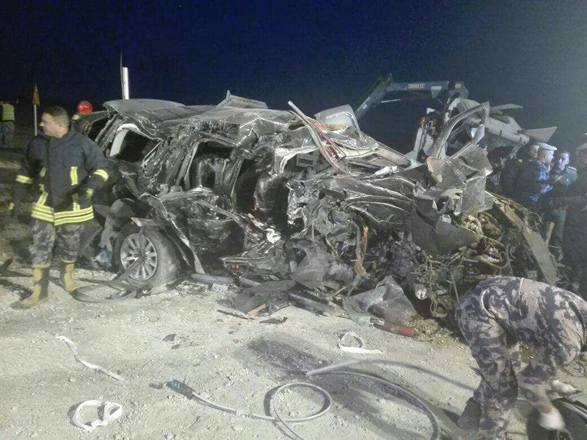 A Civil Defence Department officer stands next to the wreckage of Deputy Mohammad Amamreh’s vehicle which was completely destroyed following an accident that also involved a winch truck on the Desert Highway on Saturday evening (Photo courtesy of Traffic Department)