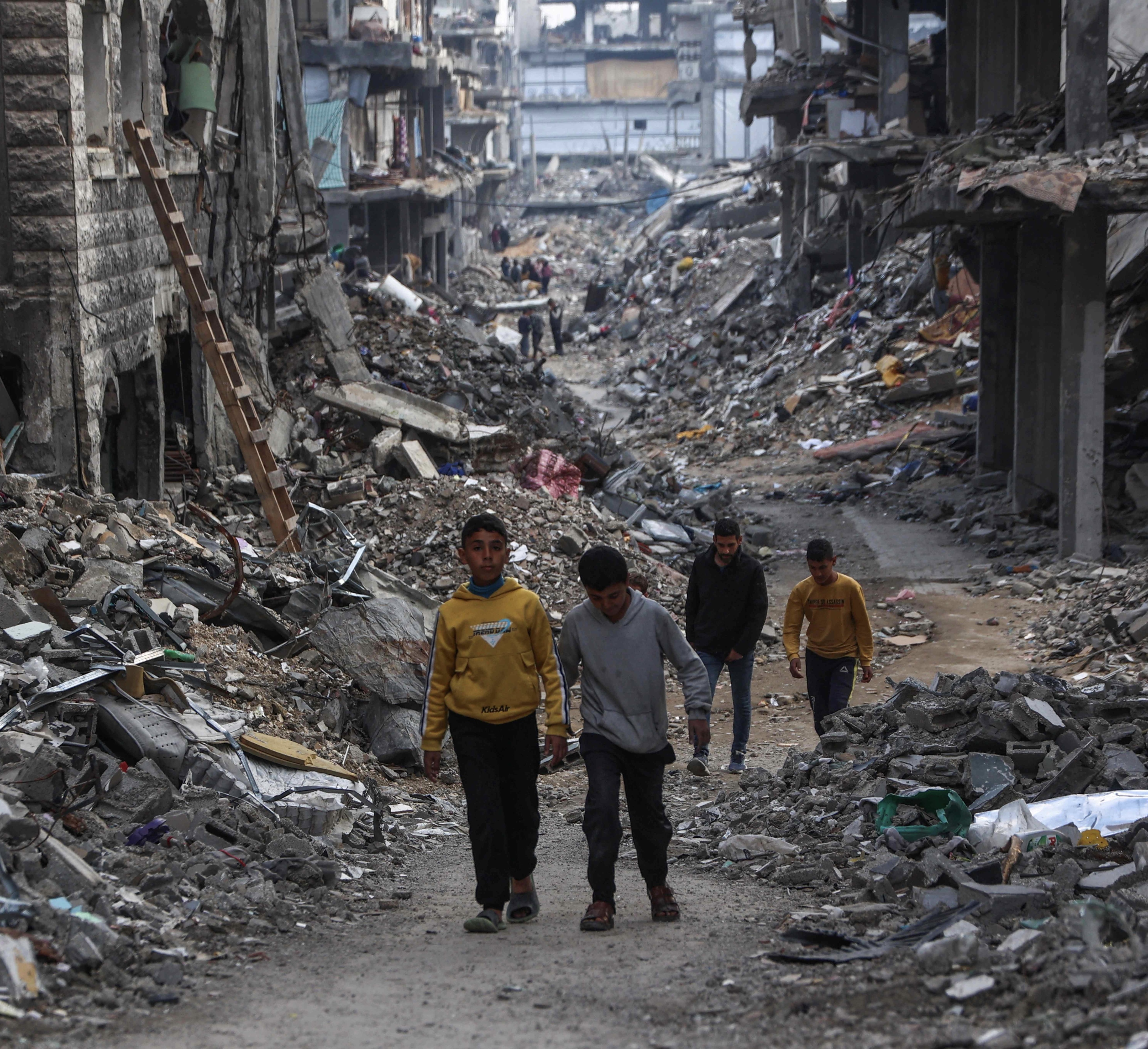 Palestinians walk in a devastated neighbourhood in Beit Lahia in the northern Gaza Strip, ahead of the iftar fast-breaking meal during the Muslim holy month of Ramadan on March 9, 2025 (AFP photo)
