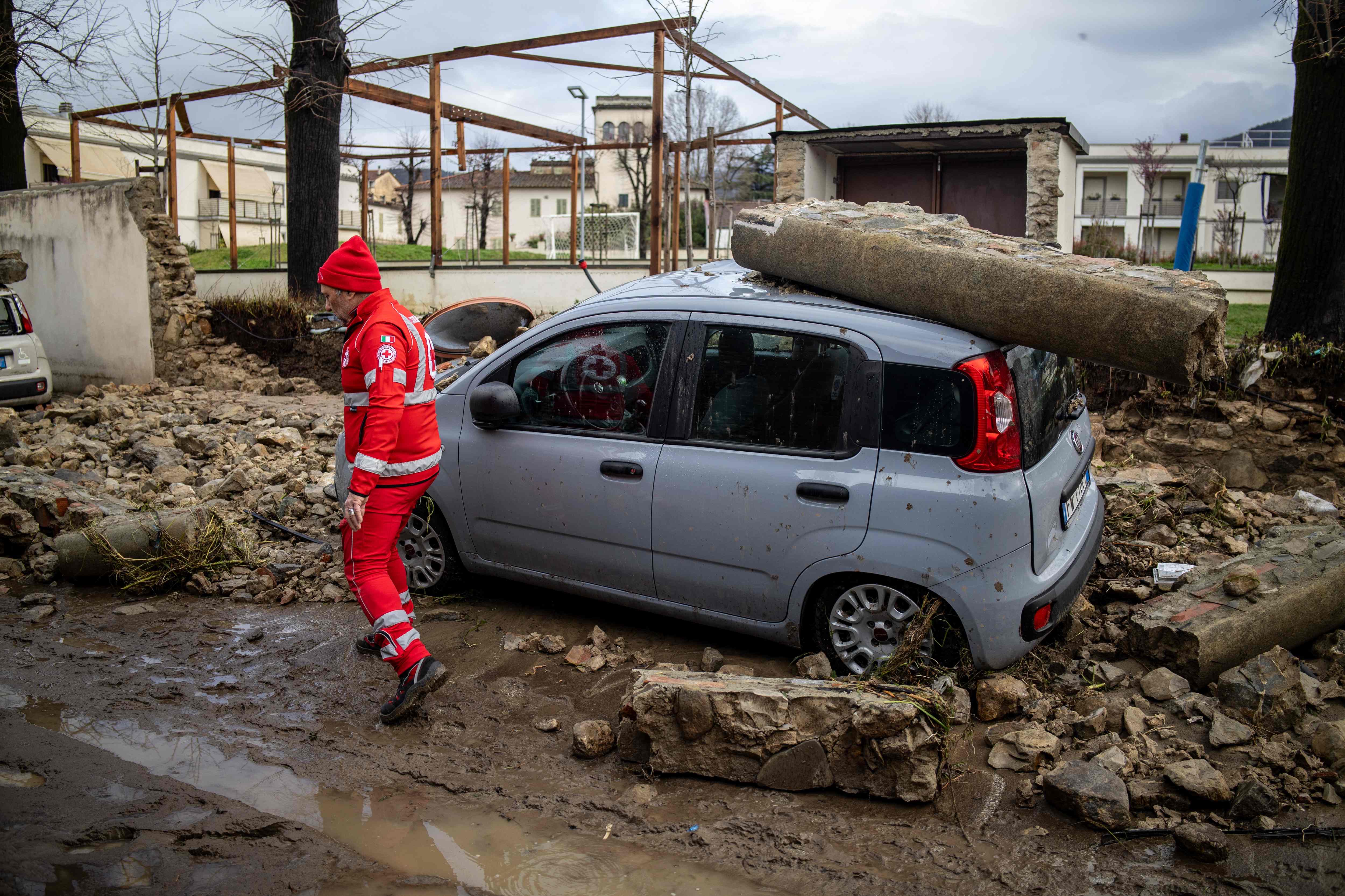 A picture shows damaged cars after a wall fell due to floods in Sesto Fiorentino near Florence Saturday (AFP photo)
