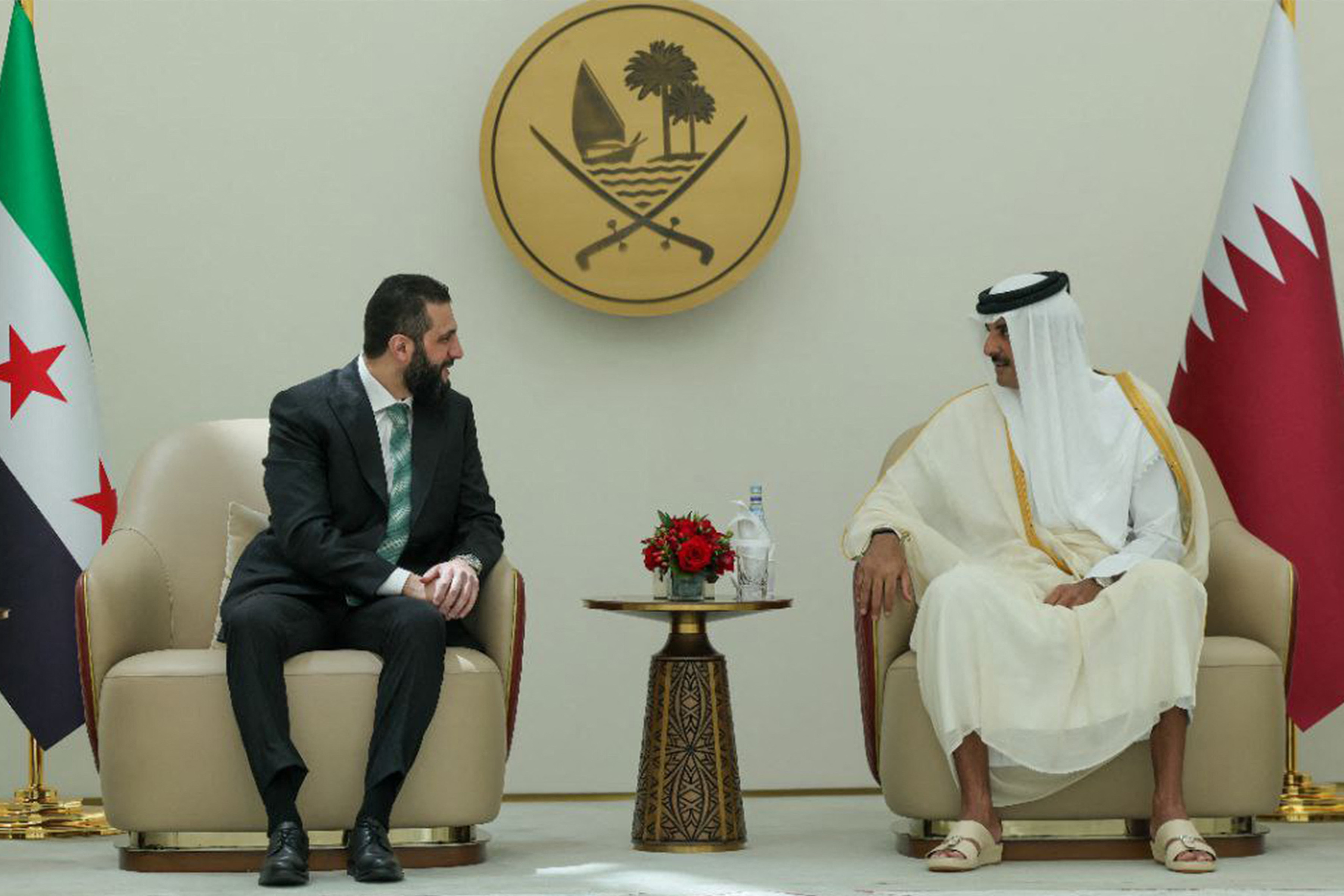 This handout picture released by the official Syrian Arab News Agency (SANA) shows Syria's interim president Ahmed Al Sharaa (L) being received by Qatar's Emir Sheikh Tamim bin Hamad Al Thani (R) in Doha on April 15, 2025 (AFP photo)