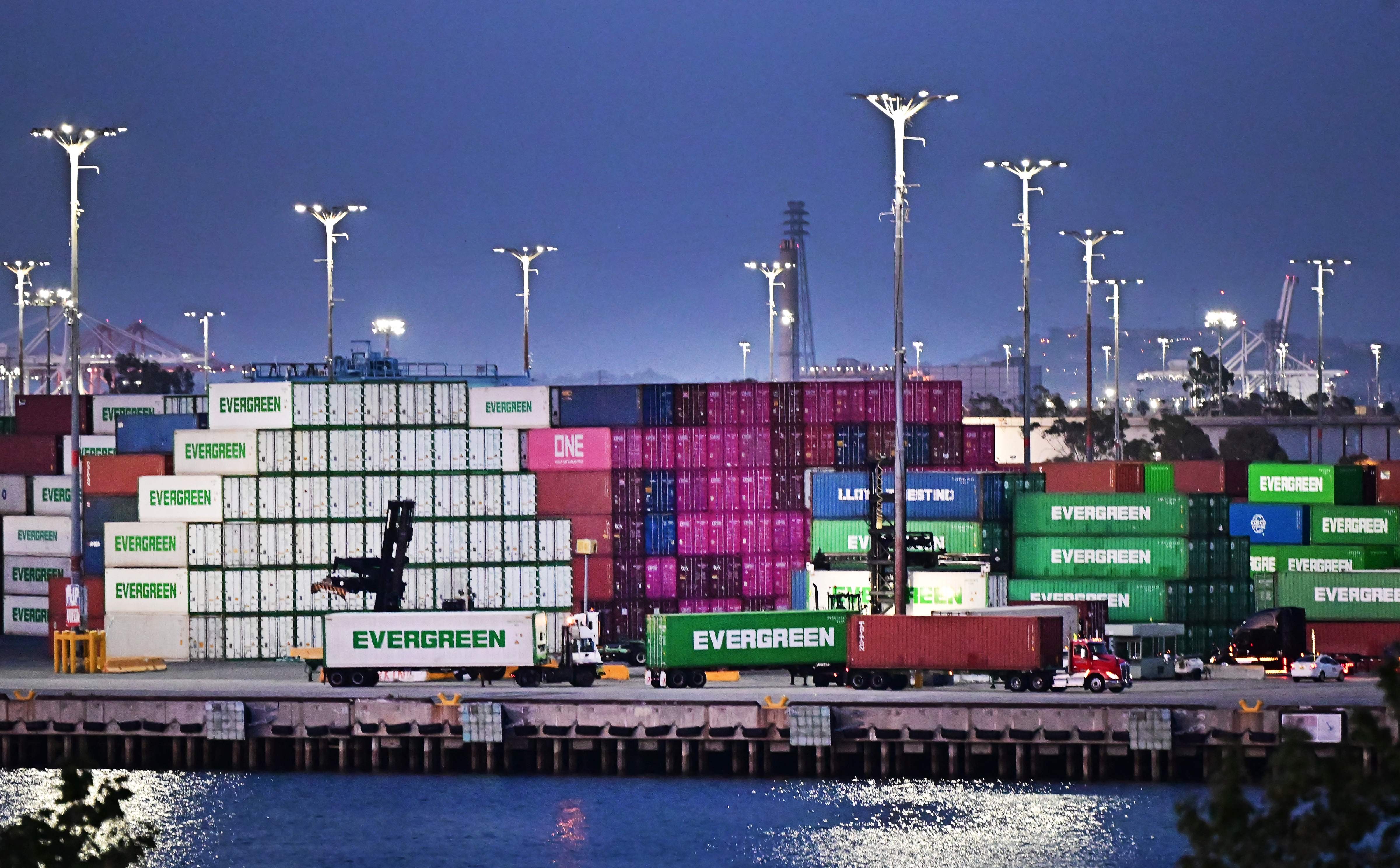 Container trucks make their way past shipping containers stacked high at the Port of Los Angeles on April 14, 2025 in Los Angeles, California (AFP photo)