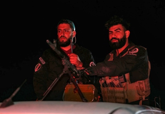 Members of Syria's security forces stand guard at a checkpoint at the entrance of Jaramana near Damascus early on May 2, 2025 (AFP photo)