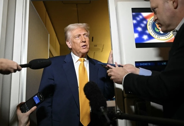US President Donald Trump speaks to reporters during the flight from Palm Beach to Miami aboard Air Force One on April 12, 2025 (AFP photo)