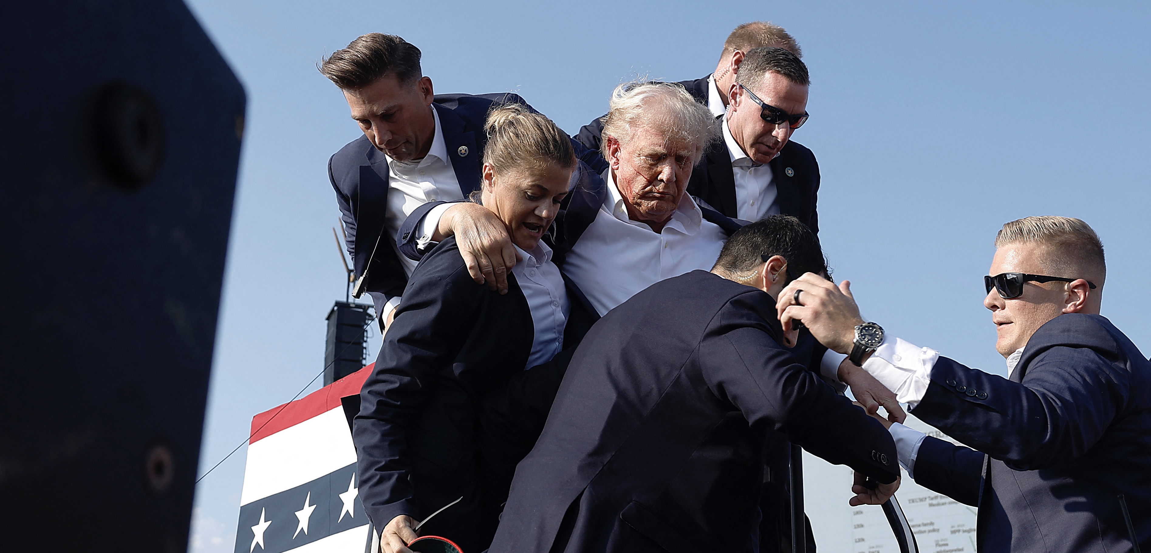 Republican presidential candidate former president Donald Trump pumps his fist as he is rushed offstage during a rally on Saturday in Butler, Pennsylvania (AFP photo)
