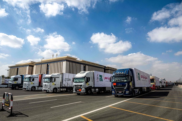 A convoy of trucks loaded with humanitarian aid supplies for  the Gaza Strip waits at Egypt's New Administrative Capital,  about 45 kilometres east of Cairo, on Sunday (AFP photo)