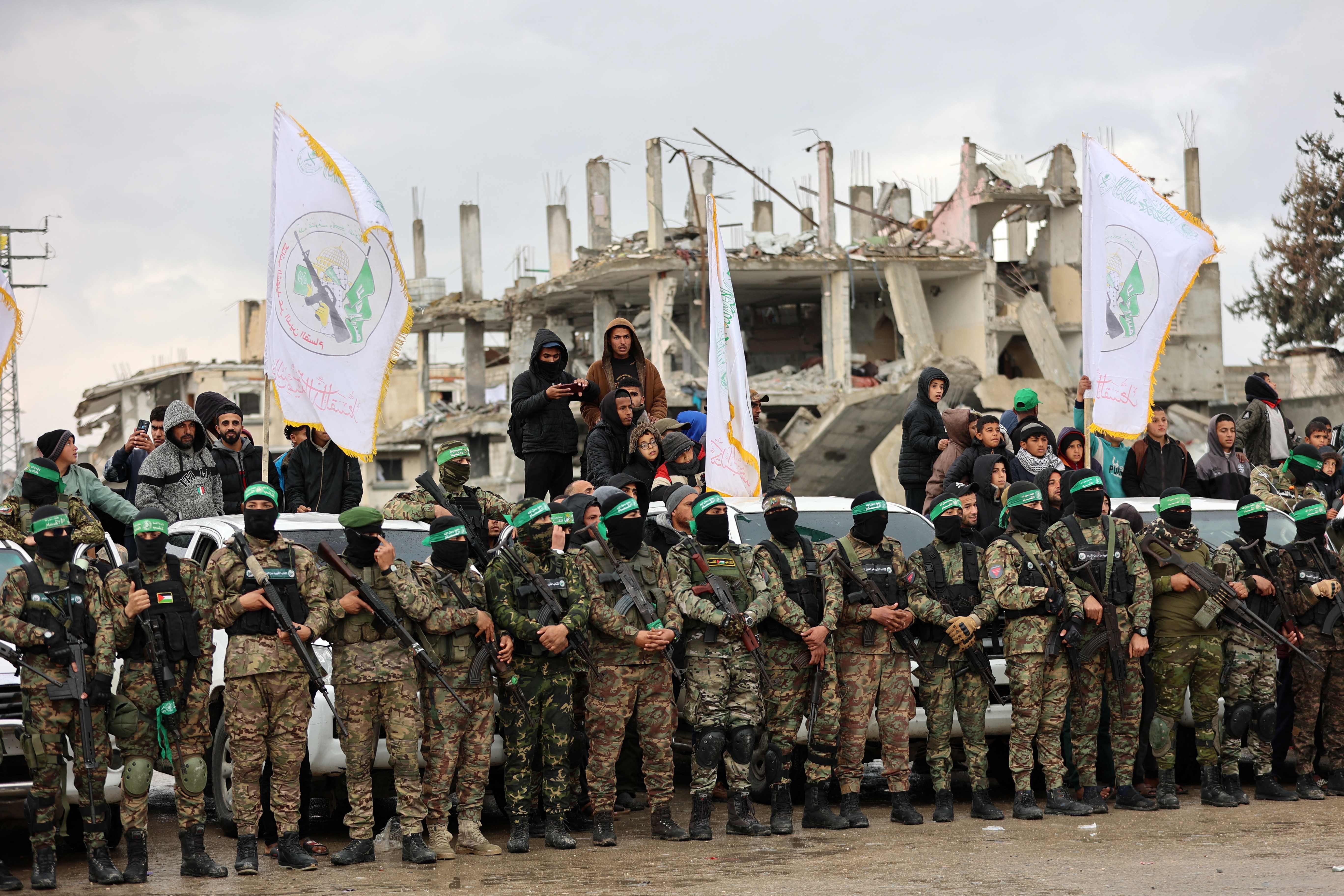 Palestinians and Hamas fighters gather at the site of the handing over of two Israeli hostages in Rafah in the southern Gaza Strip, as part of the seventh hostage-prisoner release on February 22, 2025 (AFP photo)