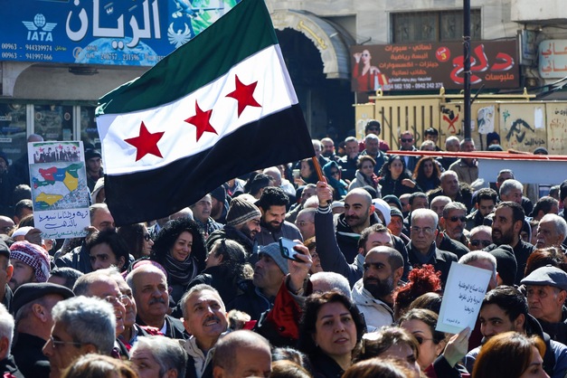Syrians lift placards as they demonstrate in the central Karama Square of the southern city of Suwayda on February 25, 2025, in rejection of statements made by Israel's premier on the weekend. (AFP photo)