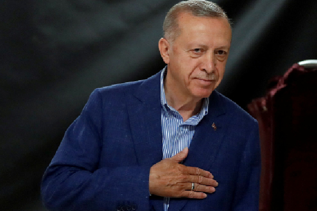 Turkey's President and presidential candidate of AK Party Recep Tayyip Erdogan gestures at the polling station on the day of the presidential runoff vote in Istanbul on Sunday (AFP photo)