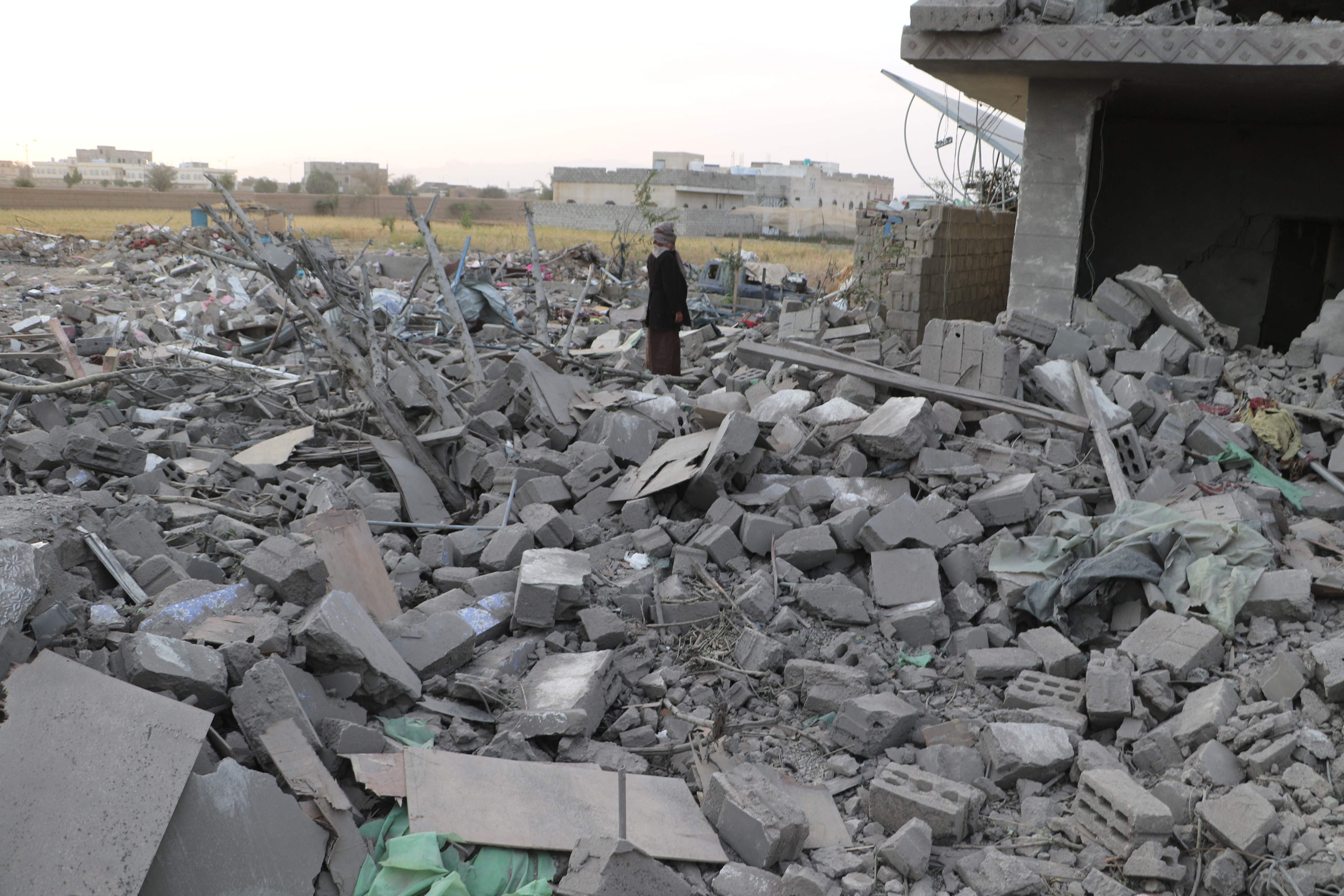 A man inspects the rubble of a house hit by a US strike on the weekend in Yemen's northern Saada province on March 17, 2025