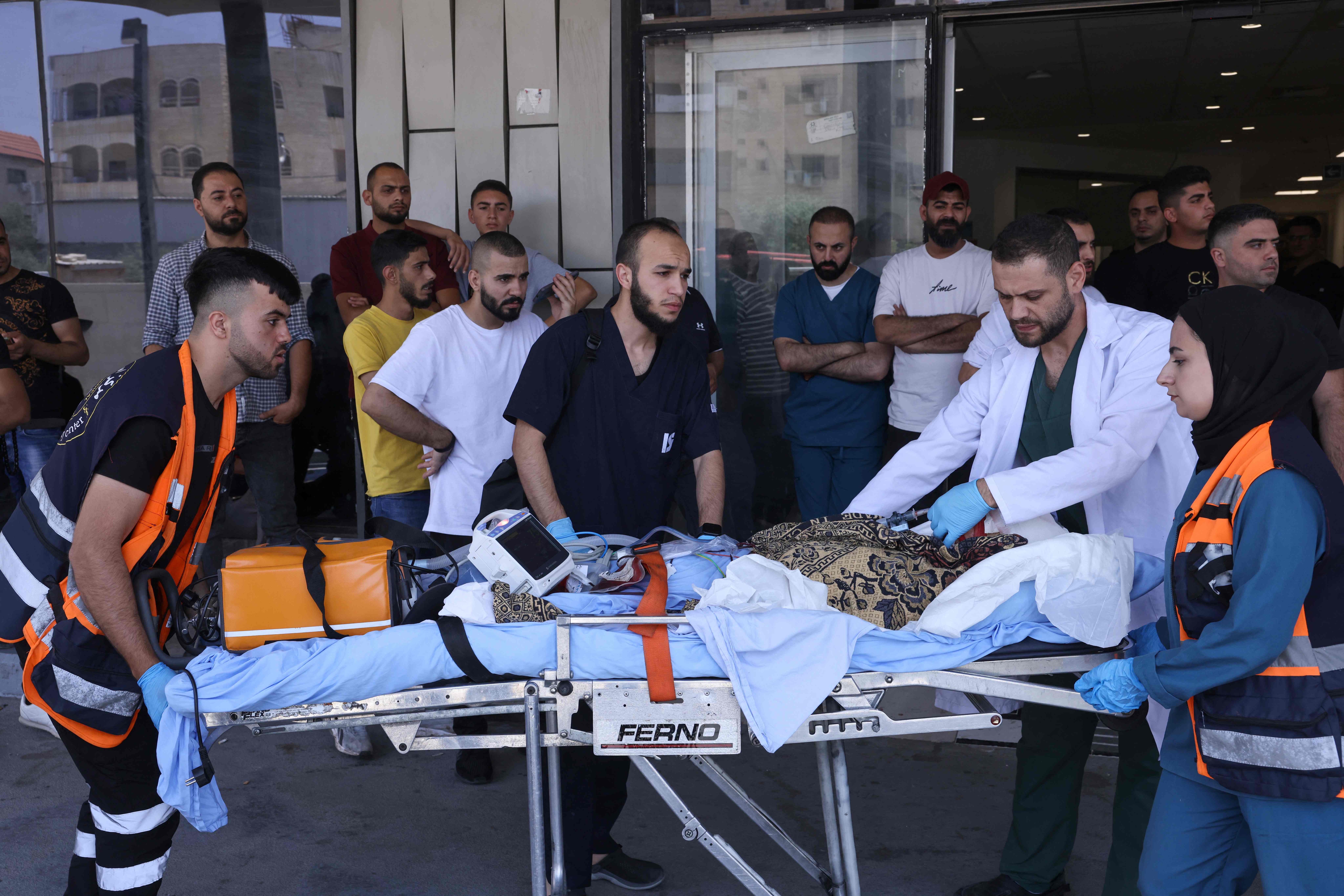 Palestinian medics transport an injured person into a hospital during an Israeli military operation in Jenin city in the occupied West Bank on Monday (AFP photo)