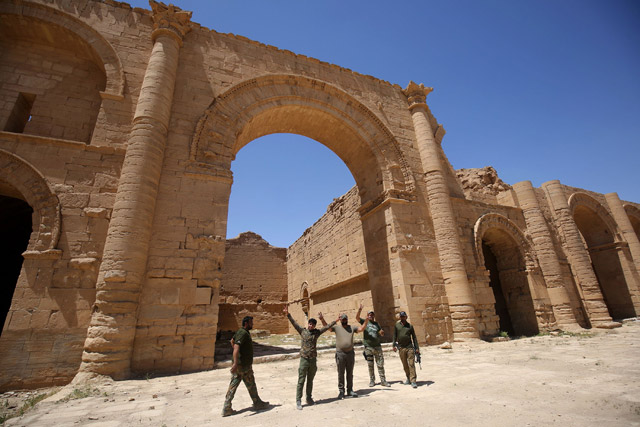 A picture shows Iraqi government forces celebrating at the UNESCO-listed ancient city of Hatra, south of Mosul, onThursday (AFP photo)