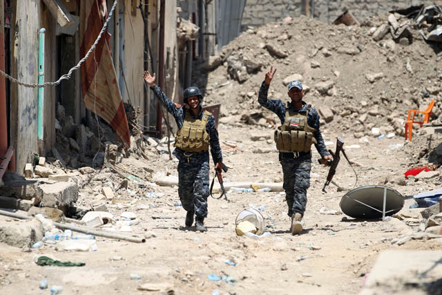 Iraqi forces gesture during their advance towards Mosul’s Old City on Sunday, during the ongoing offensive by Iraqi forces to retake the last district still held by the Daesh group (AFP photo)