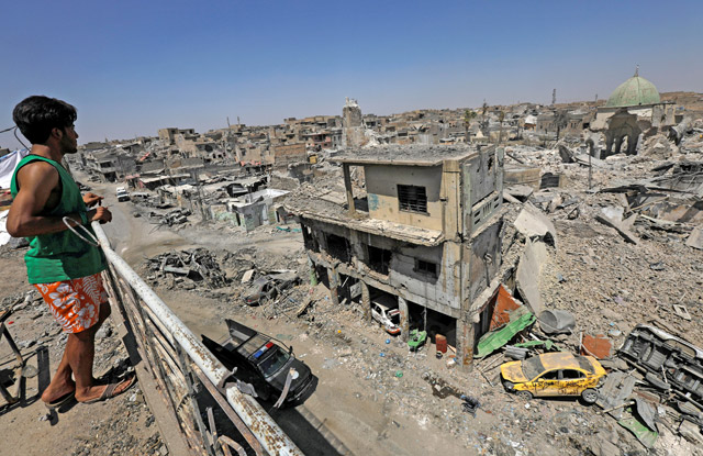 An Iraqi looks at the ruins of Grand Al Nuri Mosque and Al Hadba minaret in the destroyed Old City of Mosul, Iraq, on Saturday (Reuters photo)