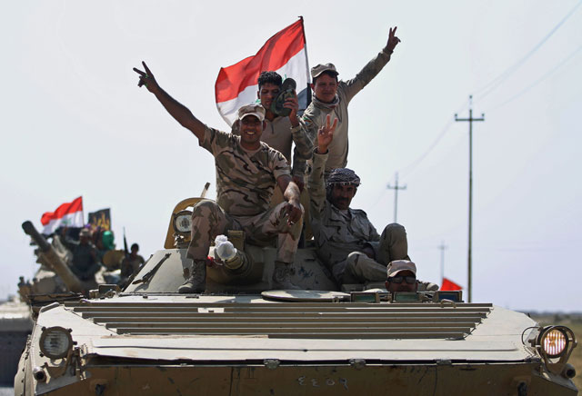 Iraqi forces drive towards Kurdish Peshmerga positions on the southern outskirts of Kirkuk  on Sunday (AFP photo)