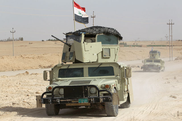 Iraqi forces and members of Al Hashed Al Shaabi advance towards the city of Al Qaim, in western Anbar province, on the Syrian border as they fight against remnant pockets of Daesh group extremists on Thursday (AFP photo)