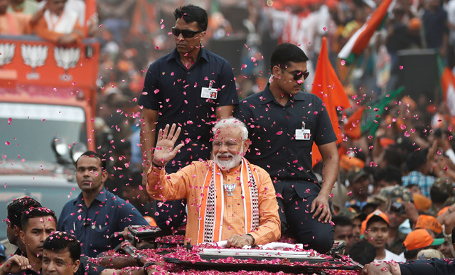 India’s Prime Minister Narendra Modi waves towards his supporters during a road show in Varanasi, India, on Thursday (Reuters photo)