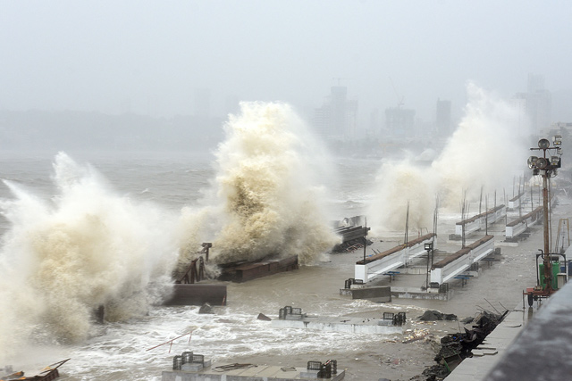 Waves lash over onto a shoreline in Mumbai on Sunday, as Cyclone Tauktae, packing ferocious winds and threatening a destructive storm, surge bore down on India, disrupting the country’s response to its devastating COVID-19 outbreak  (AFP photo)