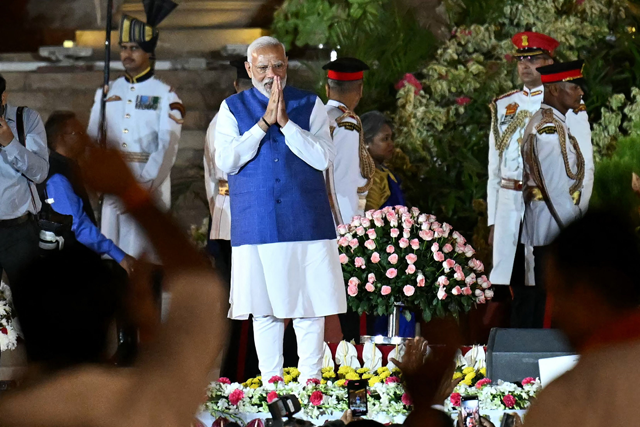 India’s newly sworn-in Prime Minister Narendra Modi gestures to the gathering during the oath-taking ceremony at presidential palace Rashtrapati Bhavan in New Delhi on Sunday (AFP photo)