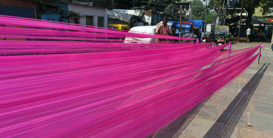 A worker dries out coloured polyster/silk yarn from which garlands are made ahead of the Hindu festival of Diwali in Ahmedabad, on Thursday (AFP photo)