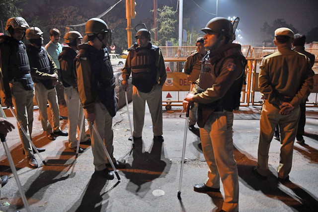 Police guard a street in an area following clashes between supporters and opponents of a new citizenship law in New Delhi, on Tuesday (AFP photo)
