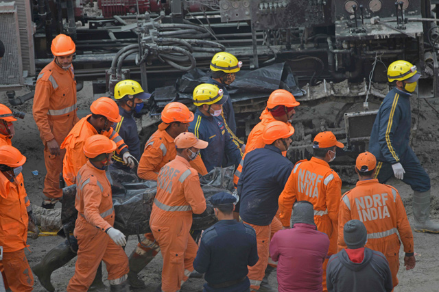 National Disaster Response Force crew carry the body of a victim following rescue efforts from Tapovan tunnel in Chamoli on Sunday (AFP photo)