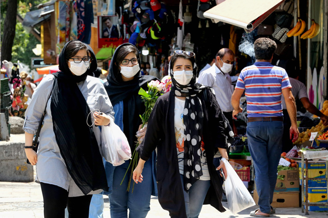 Iranian women wearing protective gear amid the COVID-19 pandemic, shop at the Tajrish Bazaar market in the capital Tehran, on Tuesday (AFP photo)