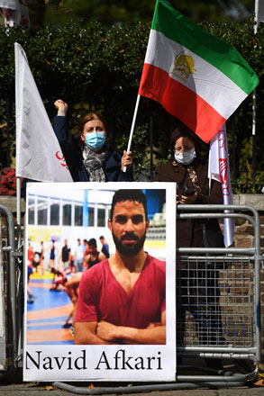 Protesters wave the Lion and Sun flag of the National Council of Resistance of Iran and the white flag of the People’s Mujahedin of Iran, two Iranian opposition groups, as they demonstrate outside the Iranian embassy in London, on September 12 (AFP photo)