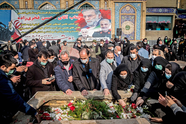 Iranian mourners attend the burial ceremony of slain nuclear scientist Mohsen Fakhrizadeh at Imamzadeh Saleh shrine in northern Tehran on Monday (AFP photo)