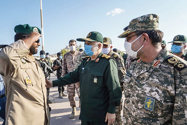 This handout photo provided by Iran's Revolutionary Guard Corps (IRGC) official website via SEPAH News on Saturday, shows Guards' chief Major General Hossein Salami (centre), accompanied by Islamic Revolutionary Guard Corps navy commander Rear Admiral Alireza Tangsiri (right), inspecting troops during his visit to the island of Abu Musa (AFP photo)