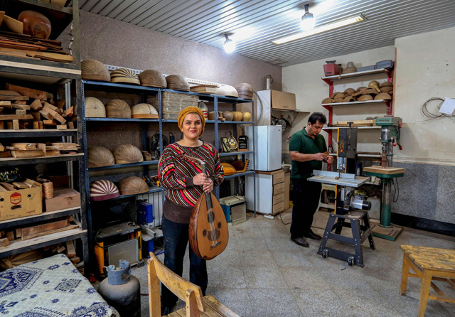   Iranian luthier Fatemeh Moussavi poses for a photo at her oud-making workshop in the capital Tehran, on December 14, 2020 (AFP photo)