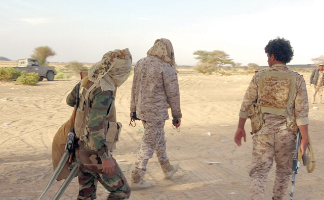 Fighters loyal to Yemen's Saudi-backed government walk at a position near the frontline against the Houthi rebels in Yemen's northeastern province of Marib, on Saturday (AFP photo)