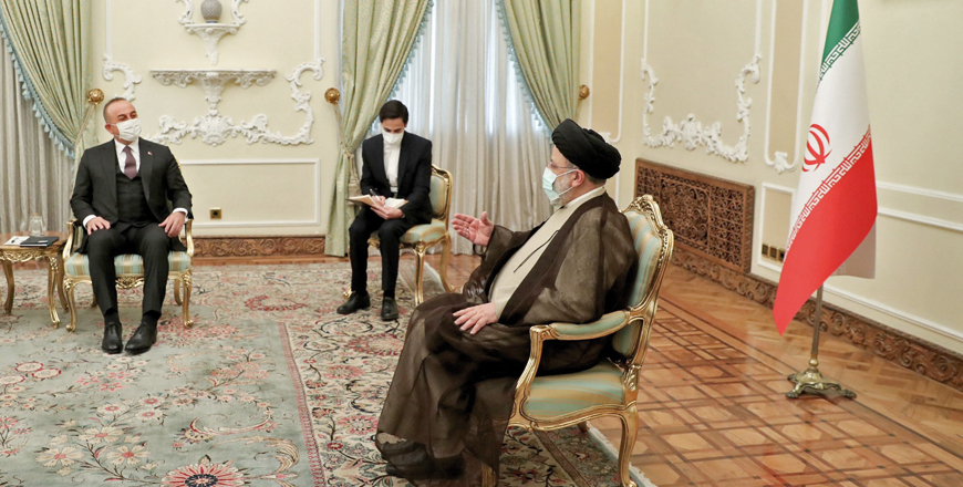 This handout photo provided by the Iranian Presidency shows Iranian President Ebrahim Raisi (right) meeting with Turkey’s Foreign Minister Mevlut Cavusoglu in Tehran, on Sunday (AFP photo)