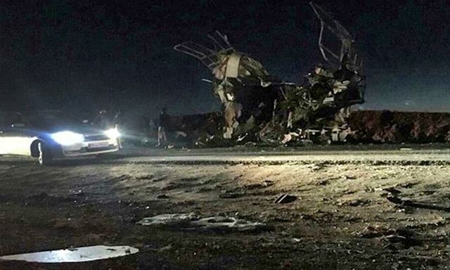 A handout photo released by the Iranian news agency Fars News shows a bus that was reportedly blown up by a suicide attack in southeastern Iran, on Wednesday  (AFP photo)