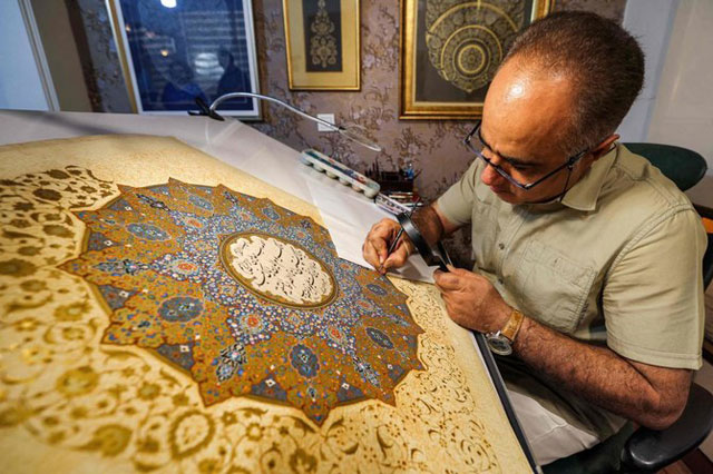 Iranian artist Mohammad Hossein Aghamiri sometimes labours for six months on a single design (AFP photo)