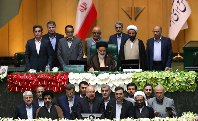 Iranian Mohammad-Bagher Ghalibaf (bottom centre) stands among members of the parliament after being elected as parliament speaker (AFP photo)