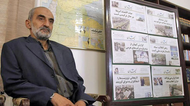 In this undated photo, Hosein Shariatmadari, director of the hardline Kayhan (Universe) newspaper group, sits next to issues of the newspaper, at his office, in Tehran, Iran (AFP photo)
