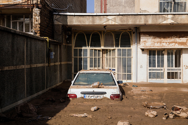 A car half-covered with mud is seen at a house in Lorestan province, Iran, on Thursday (Reuters photo)
