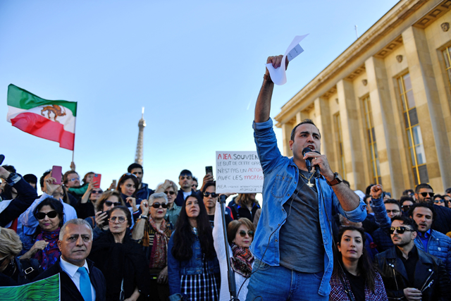 A demonstrator speaks in a microphone during a rally in support of Iranian protests in Paris on Sunday (AFP photo)
