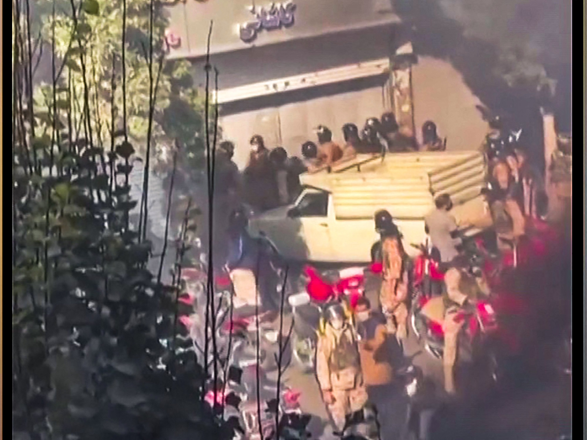 This image grab from a UGC video posted on Tuesday reportedly shows security forces trying to enter a closed shopping centre on Amir Kabir Street in Iran's capital Tehran (AFP photo)