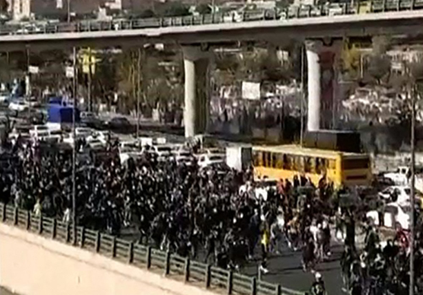 This image grab from a UGC video posted on Thursday, reportedly shows protesters marching along a highway in Iran's northern city of Karaj, northwest of the capital, seemingly after a 40th day mourning ceremony held for a slain protester (AFP photo)