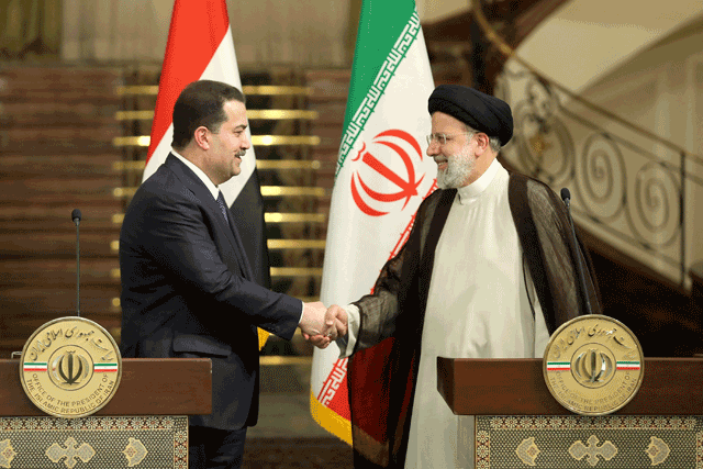 This handout photo provided by the Iranian presidency shows Iran’s President Ebrahim Raisi (right) and Iraq’s Prime Minister Mohamed Shia Al Sudani (left) shaking hands during a joint press conference in the capital Tehran on Tuesday (AFP photo)